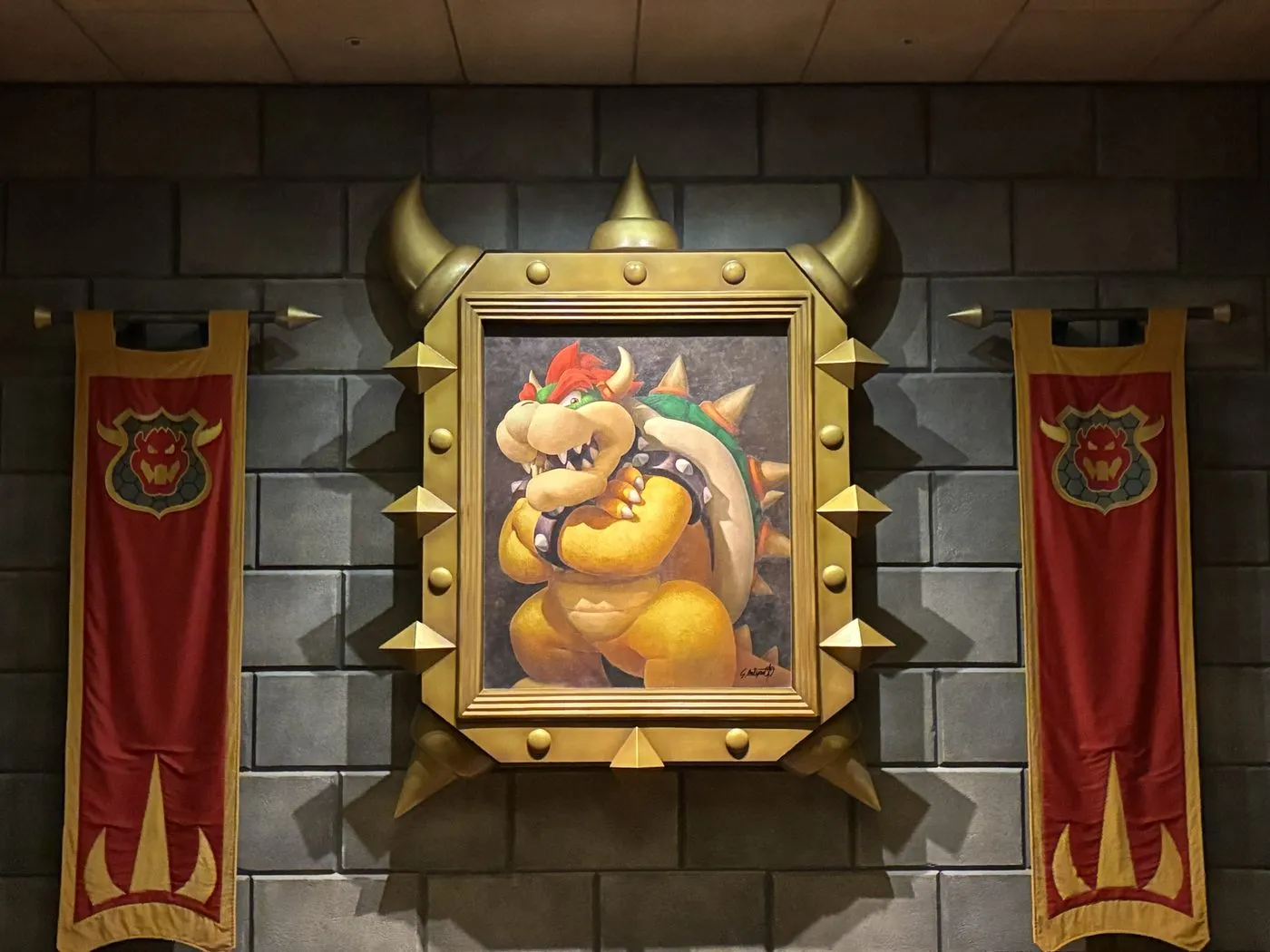 Bowser artwork displayed between banners at a gaming venue