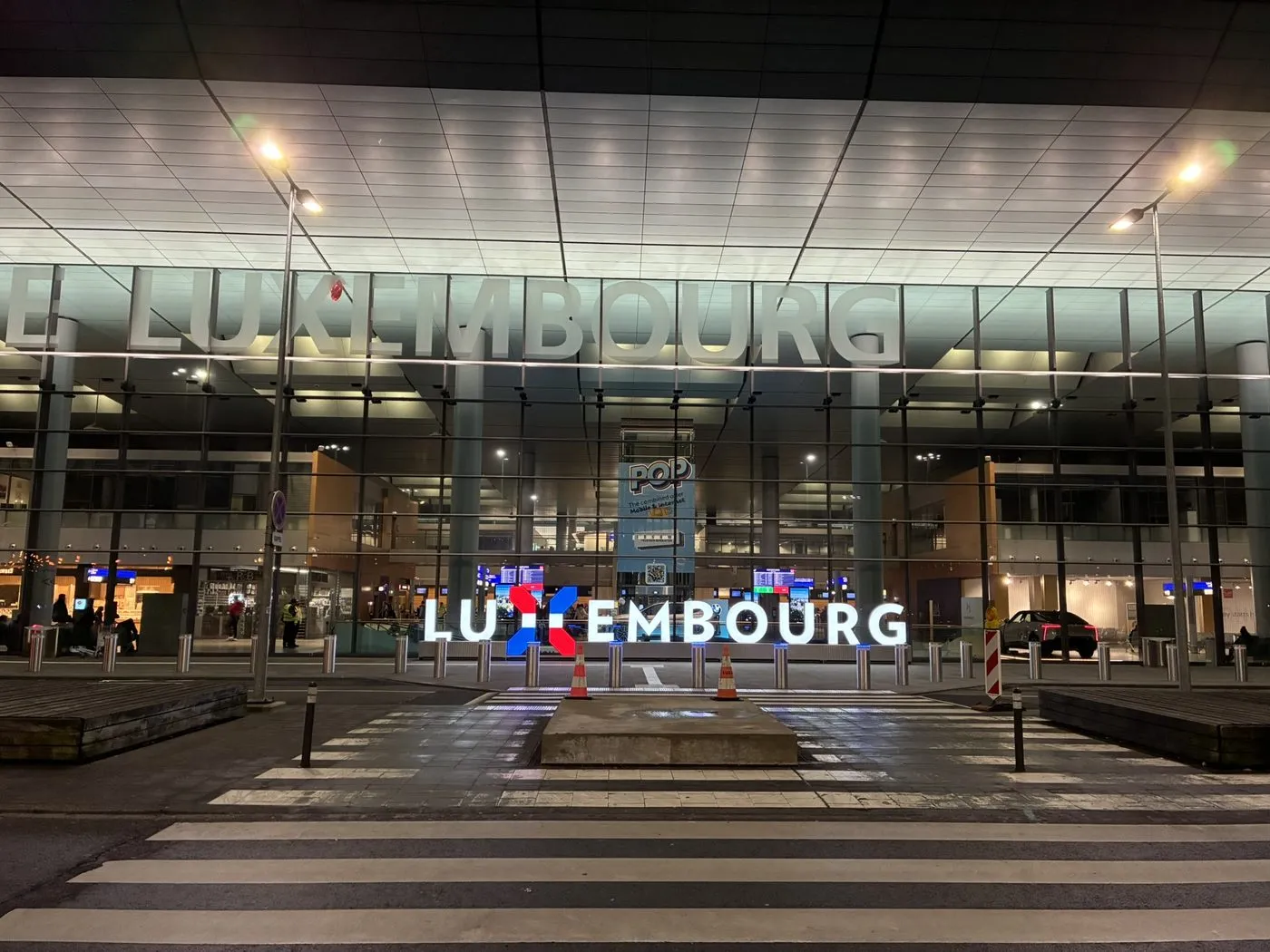 A modern building in Luxembourg City lit up at night
