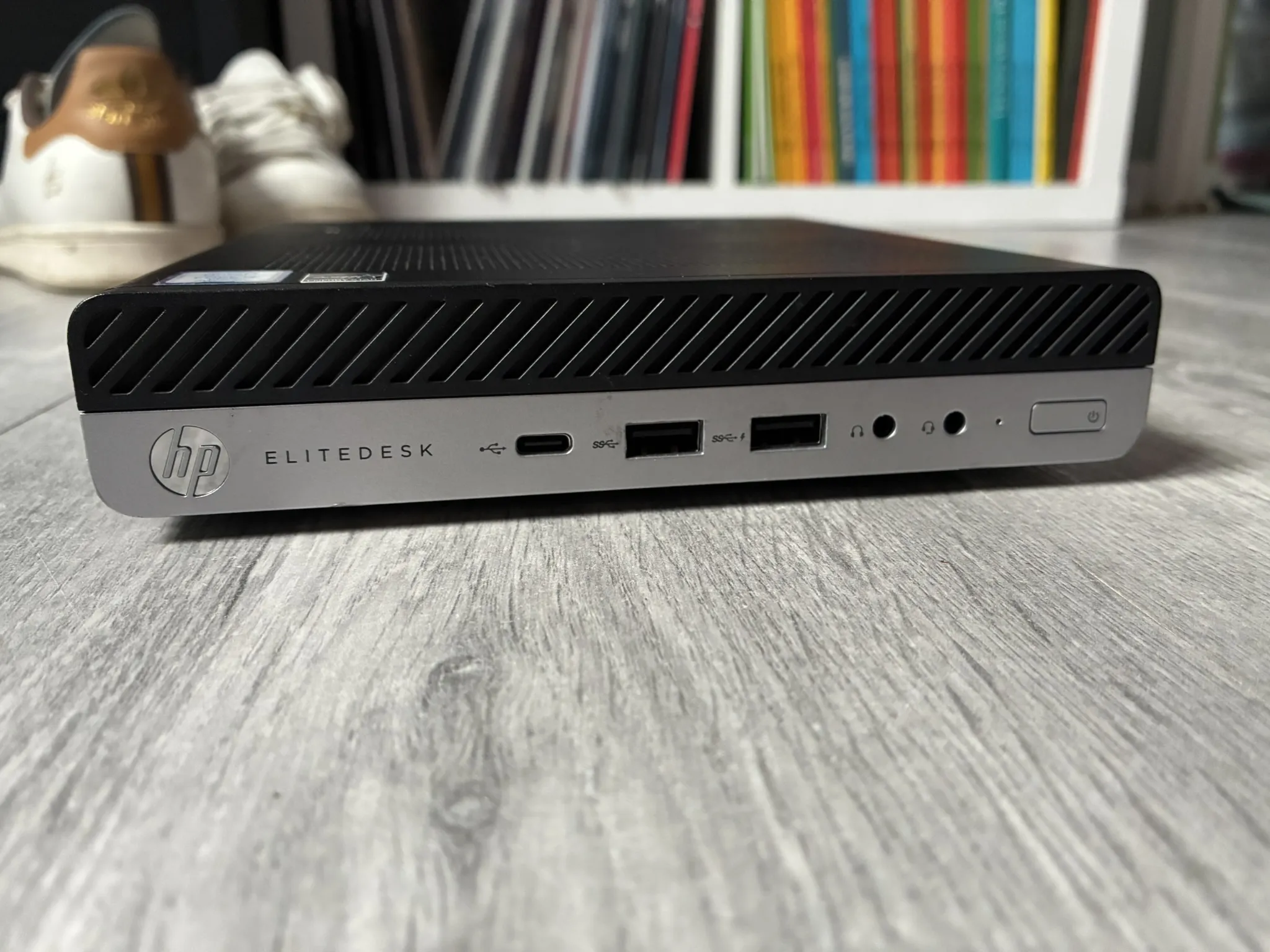 Front panel of an HP EliteDesk mini PC, showing the USB-C port, two USB-A ports, headphone jacks and the power button